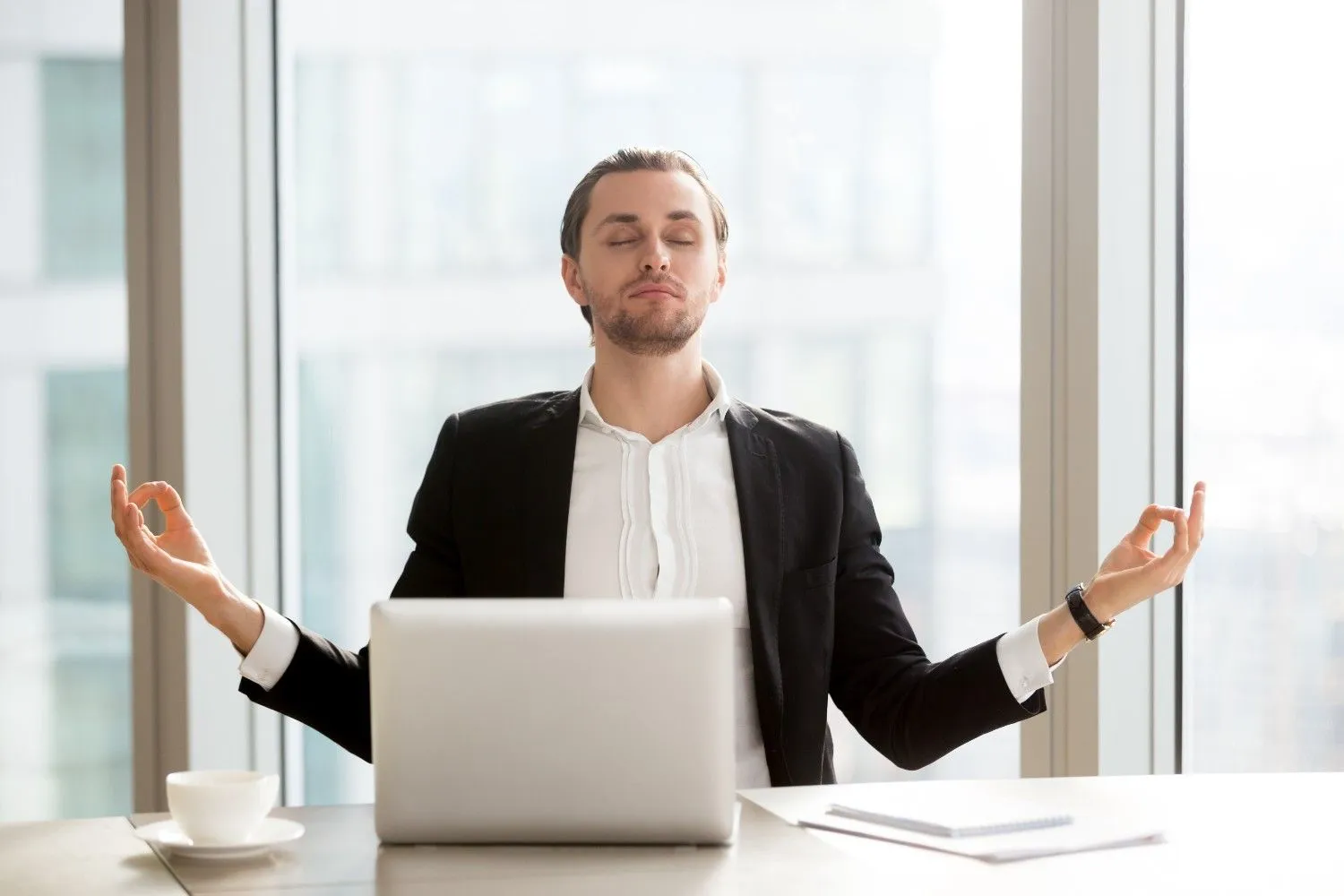 Man pausing to breathe slowly at a desk